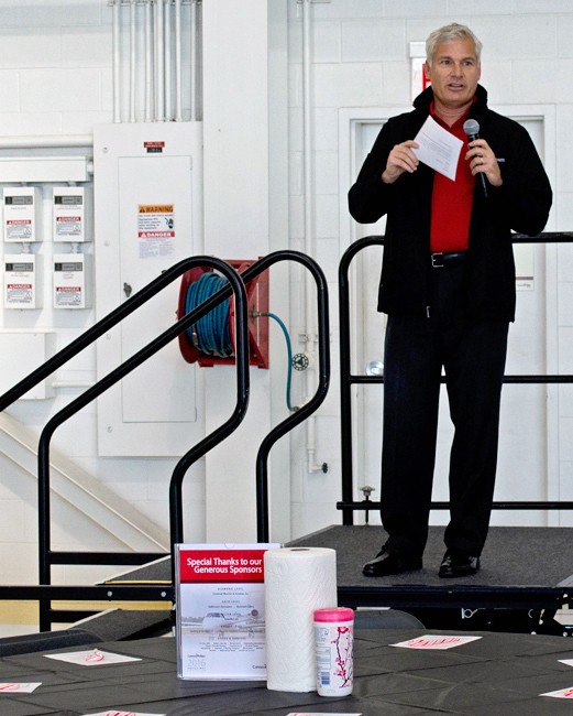 Keith Nickles on stairway platform holding microphone