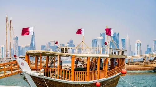 Wooden sailing vessels known as dhows in Qatar, where  ConocoPhillips has partnered with Qatar Petroleum to develop Qatargas 3.