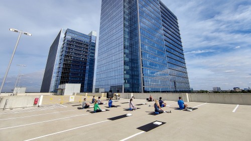 ConocoPhillips employees practice yoga atop SPIRIT ONE parking garage. 