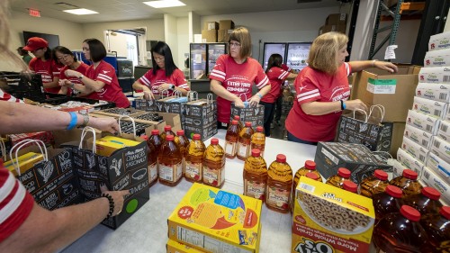 ConocoPhillips employee volunteers pack food bags at the Houston Food Bank during the 2018 United Way ‘Day of Caring.’