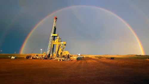 A rainbow glows over a workover rig in North Dakota.